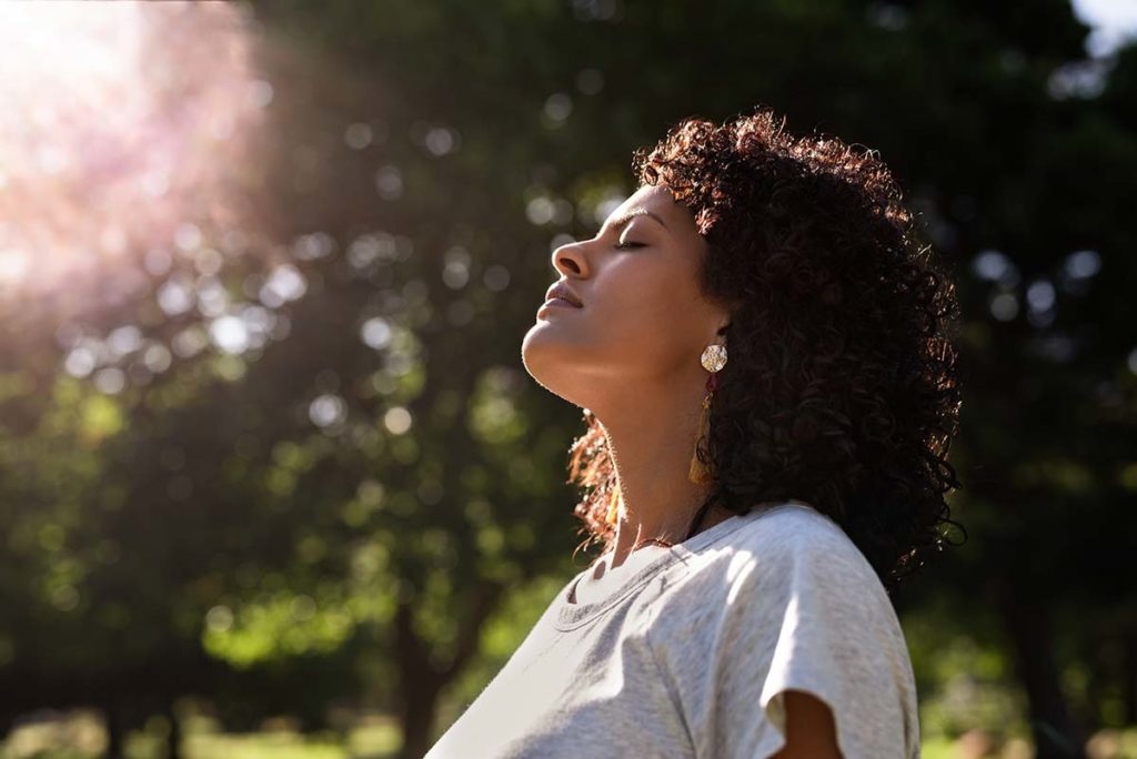 woman looking up to the sun while thinking about medical detox for alcohol
