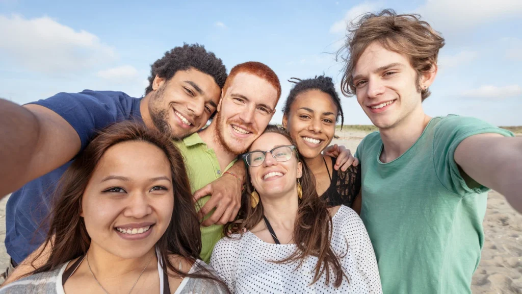 The Role of Support Groups like Benzo Buddies in Recovery - happy group of people on the beach